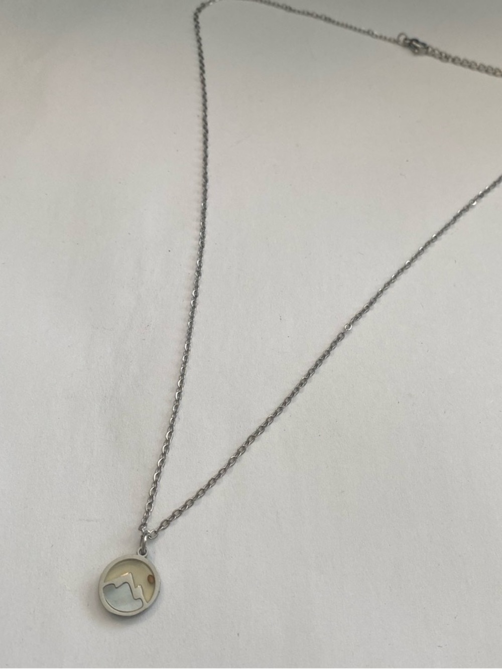 Silver-tone mountain and sun necklace